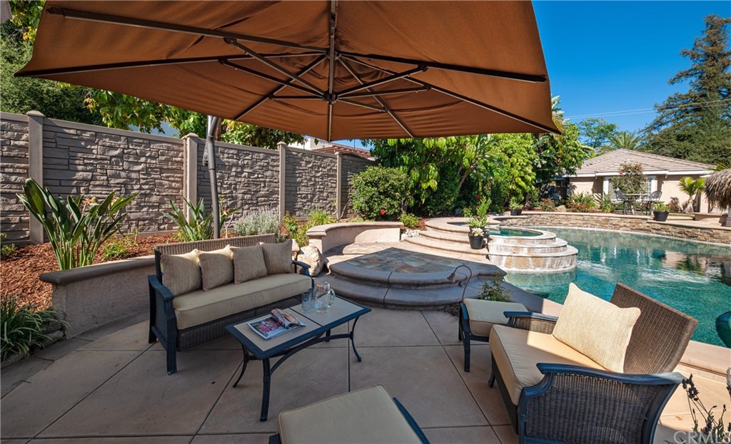 200 North Sunset Place Monrovia, CA 91016 - Photo 30 of 44 a patio with a table and chairs under an umbrella