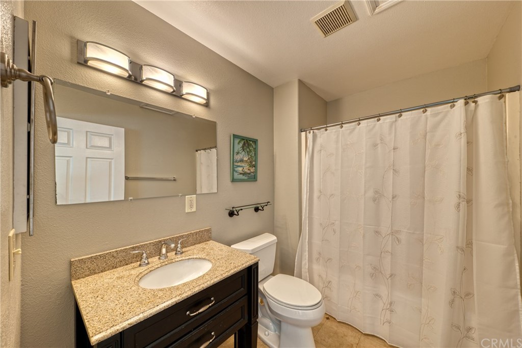 200 North Sunset Place Monrovia, CA 91016 - Photo 40 of 44 a bathroom with a granite countertop sink and a mirror