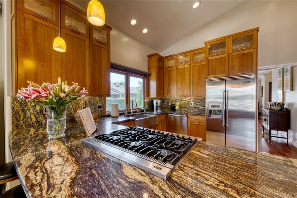 200 North Sunset Place Monrovia, CA 91016 - Photo 5 of 44 a kitchen with stainless steel appliances granite countertop a stove a refrigerator and a wooden cabinets