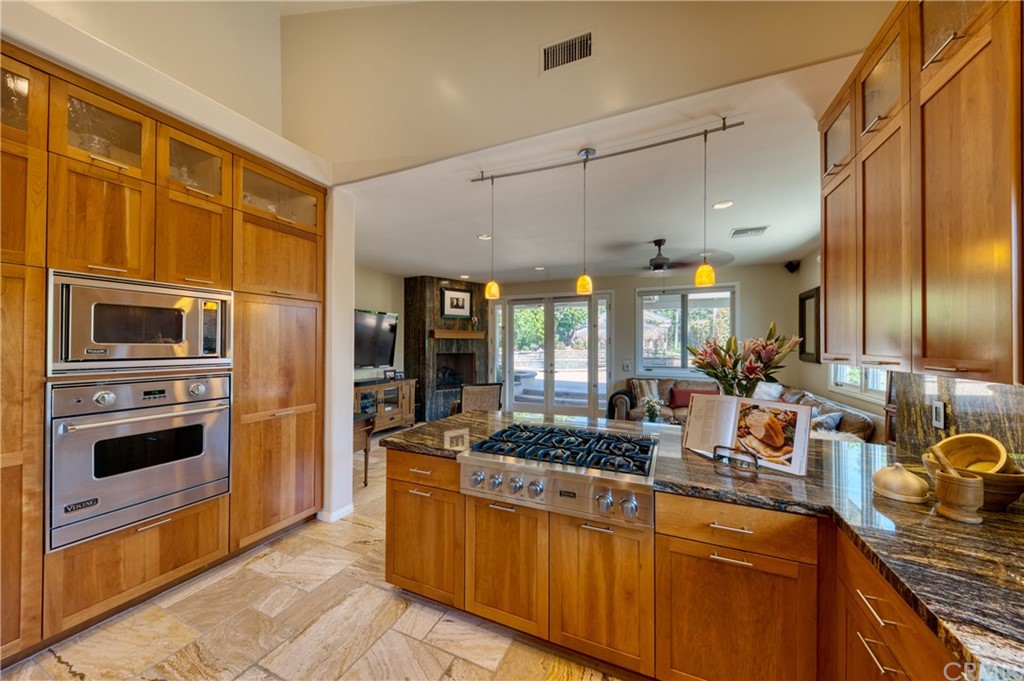 200 North Sunset Place Monrovia, CA 91016 - Photo 7 of 44 a kitchen with stainless steel appliances granite countertop a stove a sink and a refrigerator