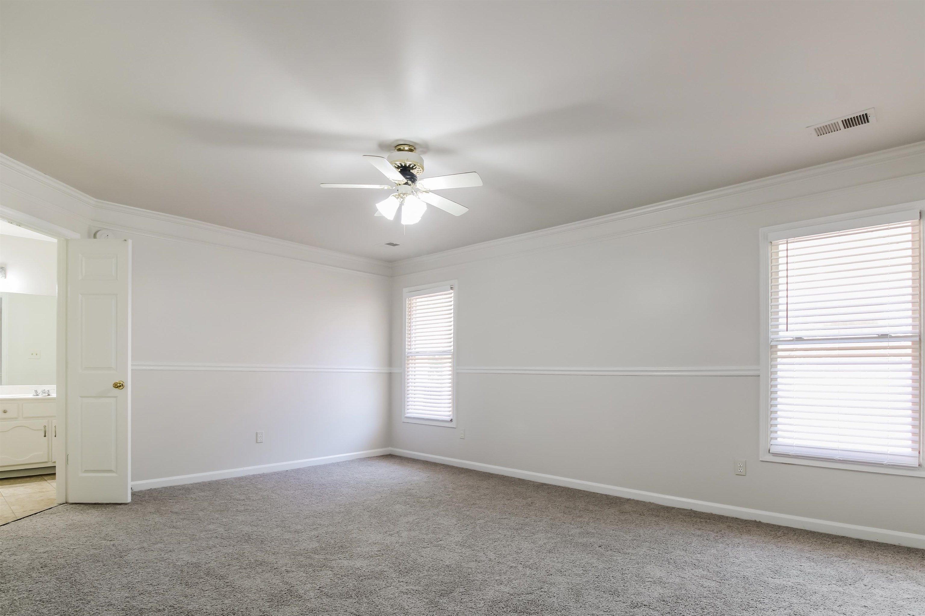 8859 Raspberry Lane Memphis, TN 38016 - Photo 10 of 16 Empty room featuring ornamental molding, carpet flooring, and ceiling fan