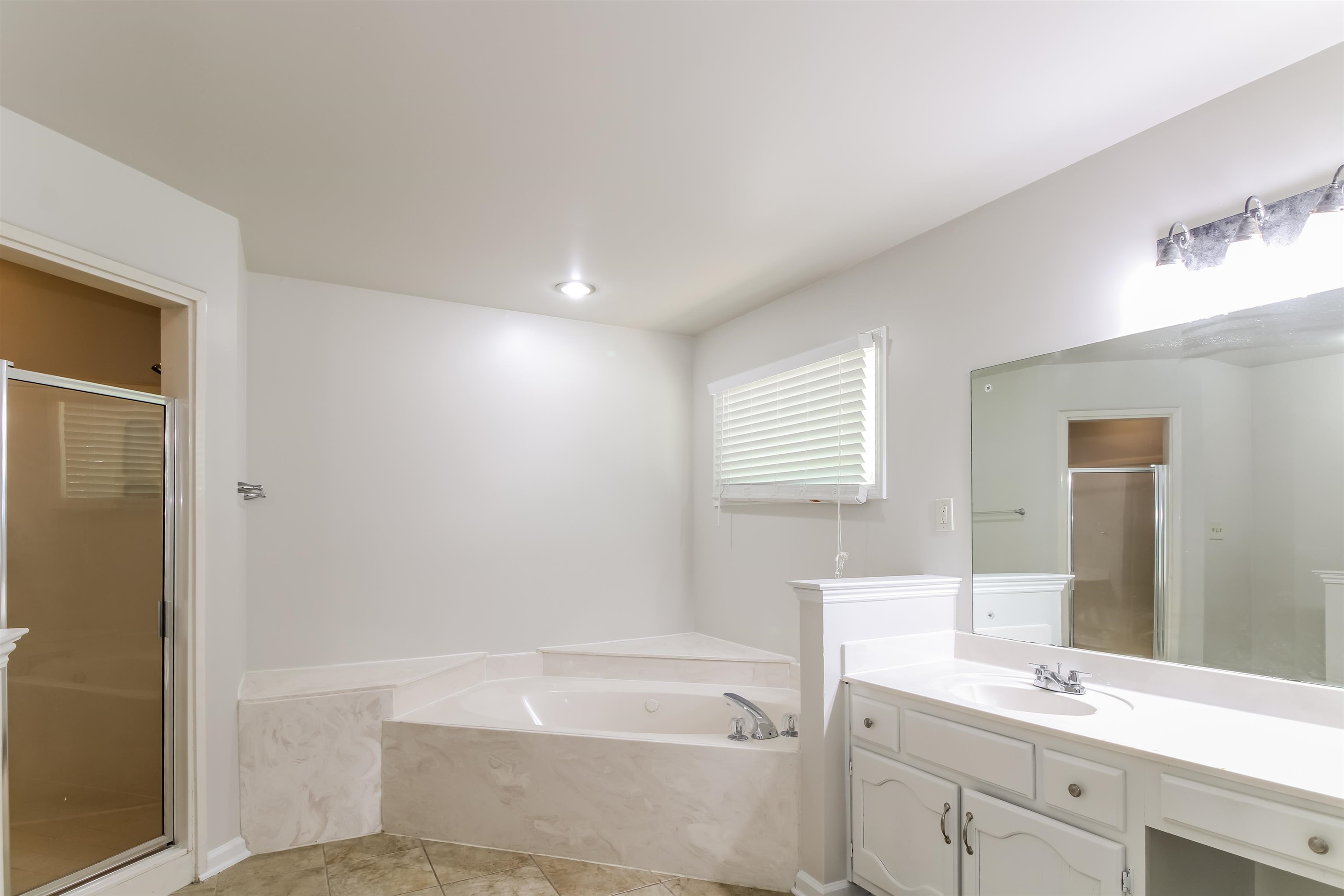 8859 Raspberry Lane Memphis, TN 38016 - Photo 11 of 16 Bathroom with vanity, separate shower and tub, and tile patterned flooring