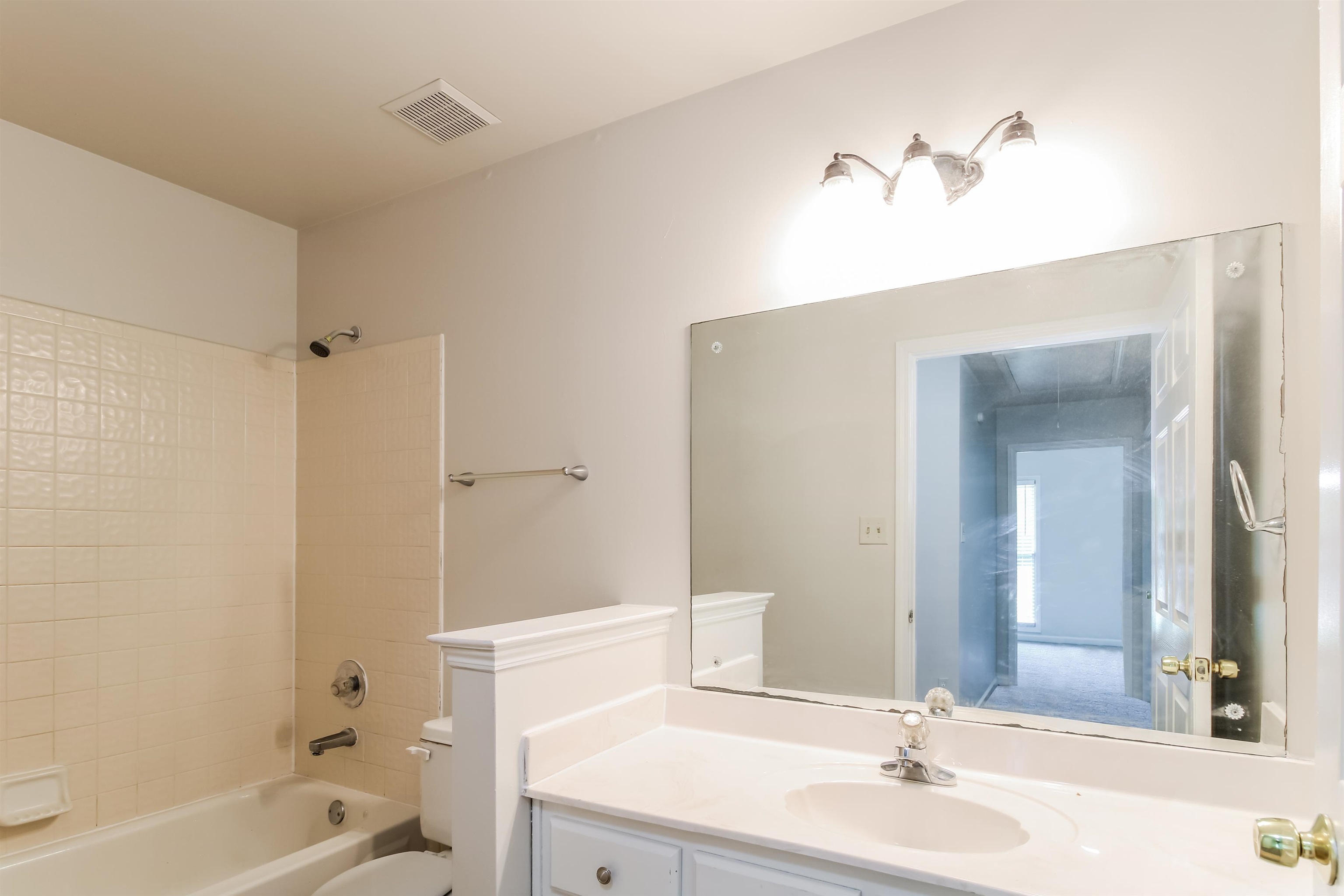8859 Raspberry Lane Memphis, TN 38016 - Photo 13 of 16 Full bathroom featuring toilet, tiled shower / bath combo, and vanity