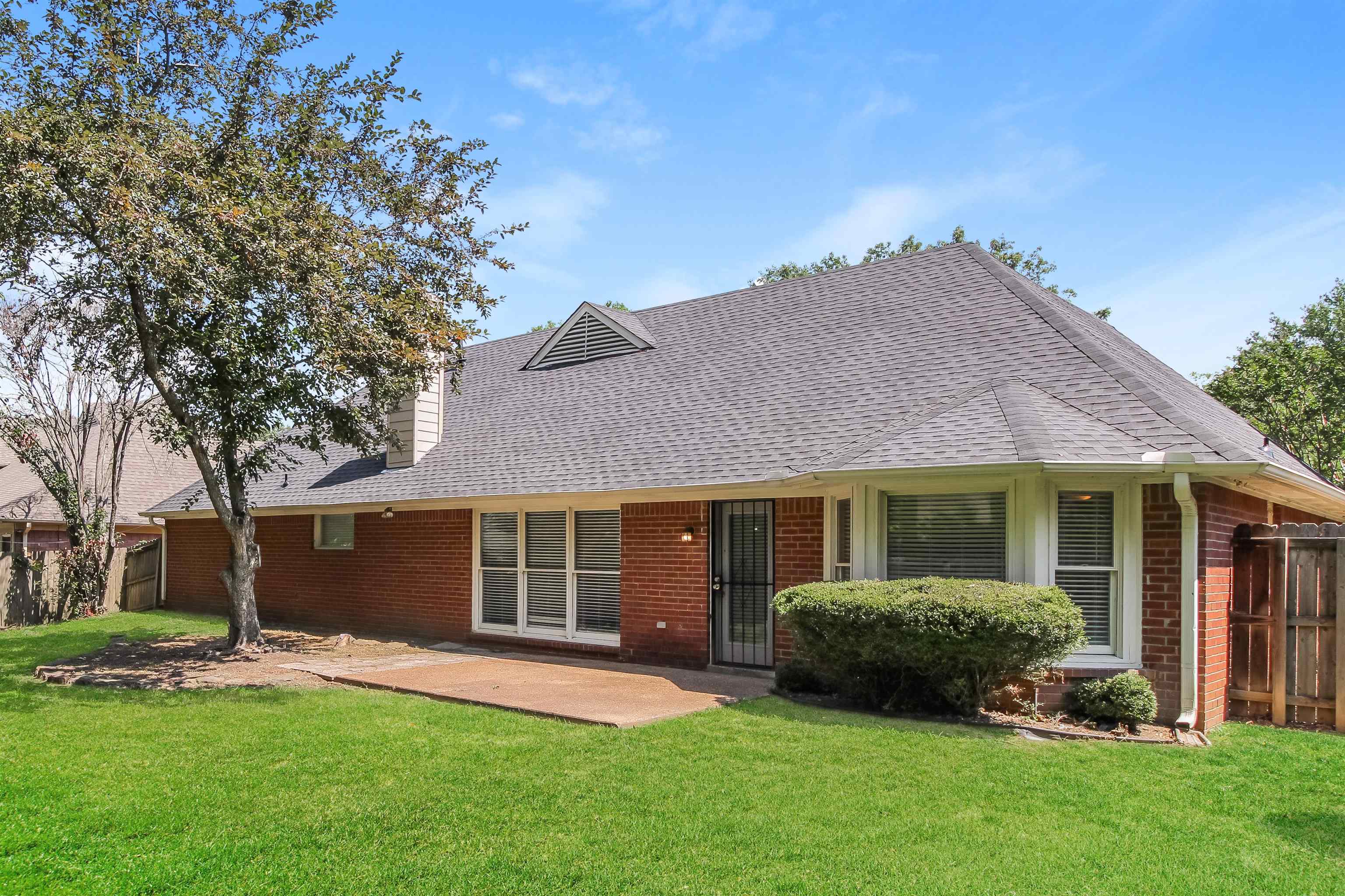 8859 Raspberry Lane Memphis, TN 38016 - Photo 14 of 16 Rear view of property with a patio and a yard