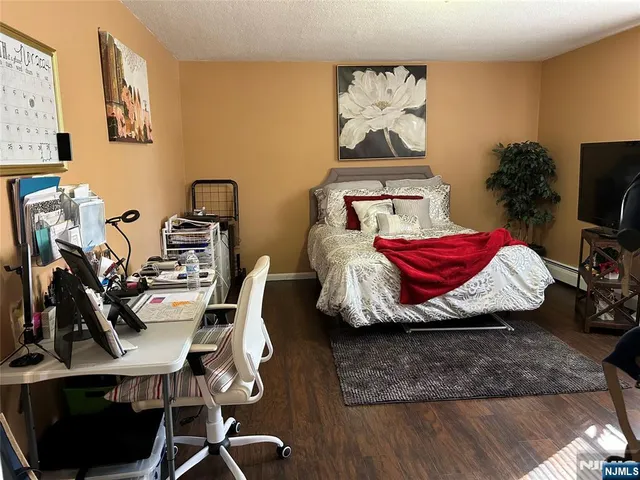 a bed room with a bed and a television