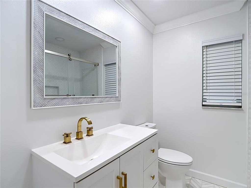 4536 Mitcher Road New Port Richey, FL 34652 - Photo 23 of 46 a bathroom with a sink toilet and mirror