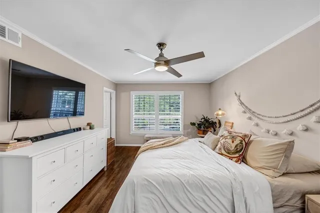 a bedroom with a large bed and a flat screen tv