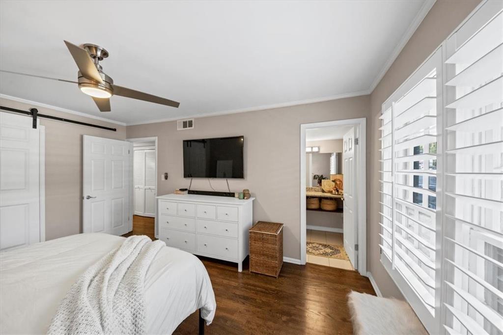 37 La Rue Place Northwest Atlanta, GA 30327 - Photo 15 of 43 a bedroom with a bed and a flat screen tv