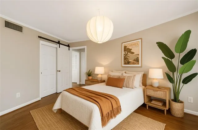 a bedroom with bed and a potted plant