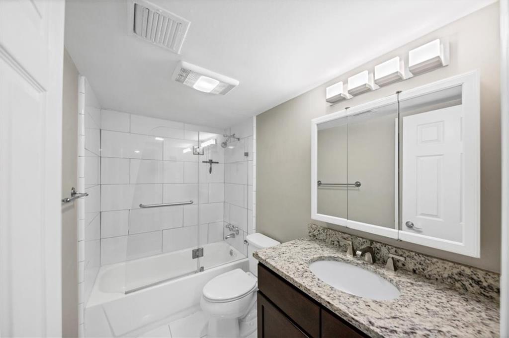 37 La Rue Place Northwest Atlanta, GA 30327 - Photo 20 of 43 a bathroom with a granite countertop sink a toilet a mirror and shower