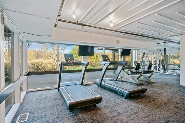 a living room with lots of furniture and a rug