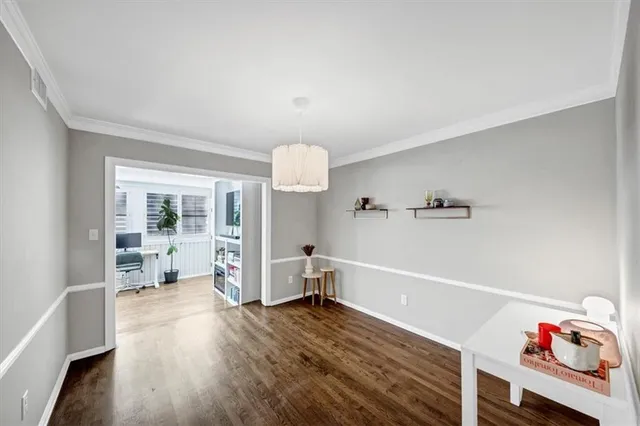 a view of a room with wooden floor and window