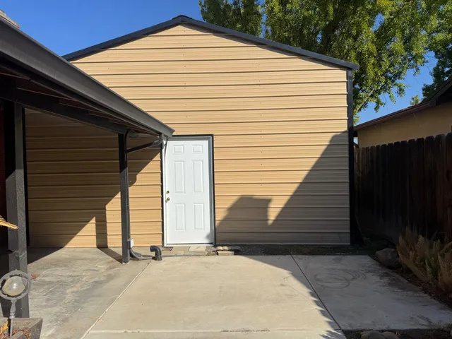 a view of house with wooden fence and floor to ceiling window and stairs
