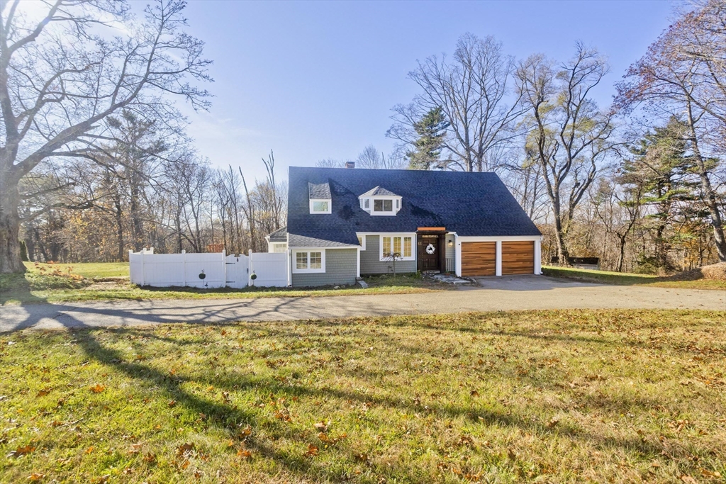 a front view of house with yard covered in snow