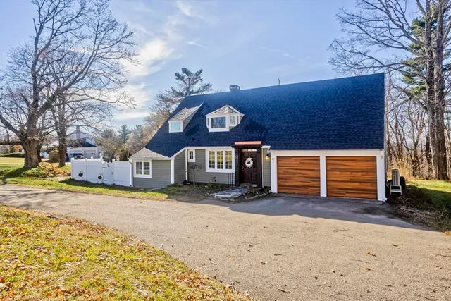 a view of a house with a yard covered in snow