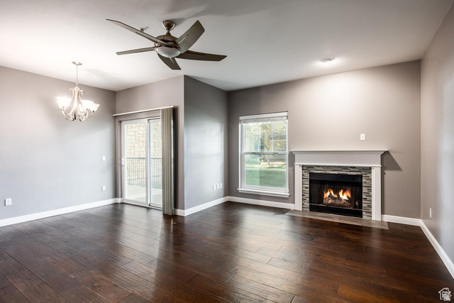 900 Bitner Road, Unit M 17 Park City, UT 84098 - Photo 5 of 29 Unfurnished living room featuring a ceiling fan, a fireplace with flush hearth, suspended lighting, and dark wood-style floors
