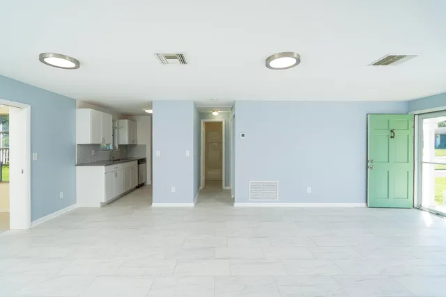 a view of a kitchen with a sink and a cabinet