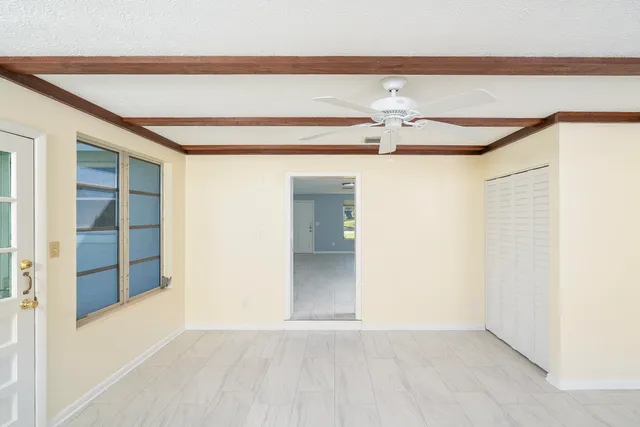 a view of an empty room with a ceiling fan