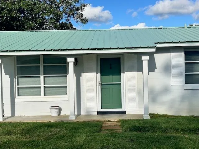 a green house with a yard