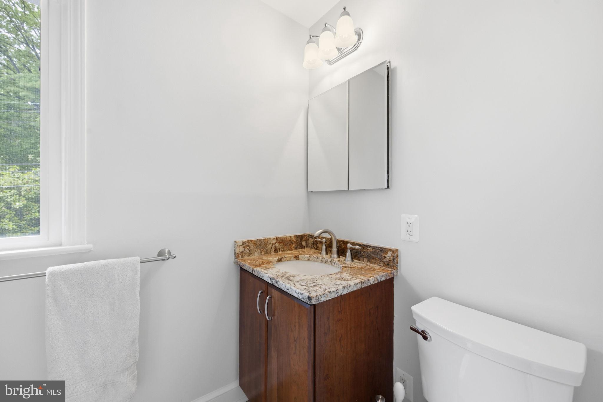 2829 29th Place Northwest Washington, DC 20008 - Photo 28 of 41 a bathroom with a granite countertop sink and a toilet