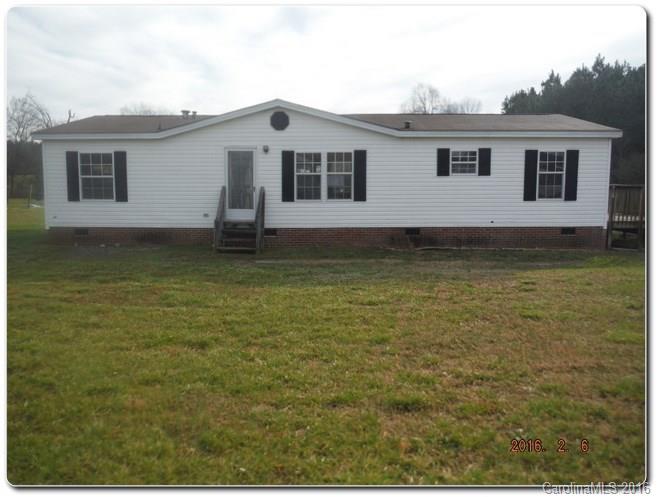 a house that has a large pool in front of it