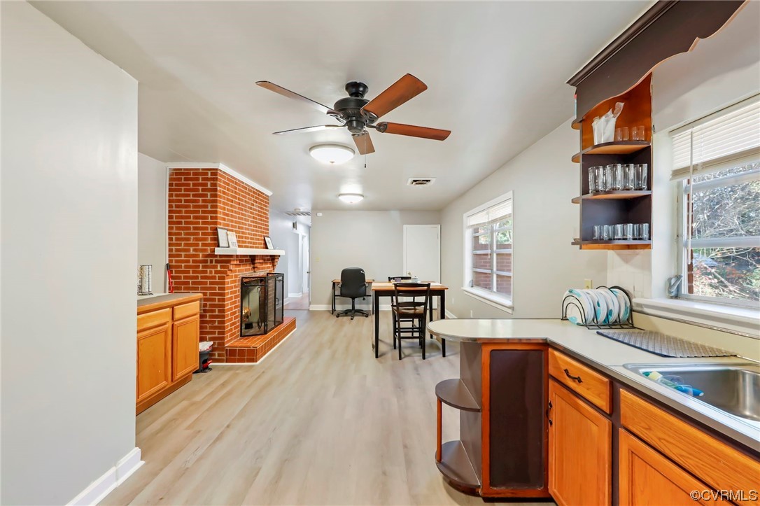 3248 West Hundred Road Chester, VA 23831 - Photo 11 of 27 a kitchen with stainless steel appliances granite countertop a refrigerator a sink dishwasher a dining table and chairs with wooden floor