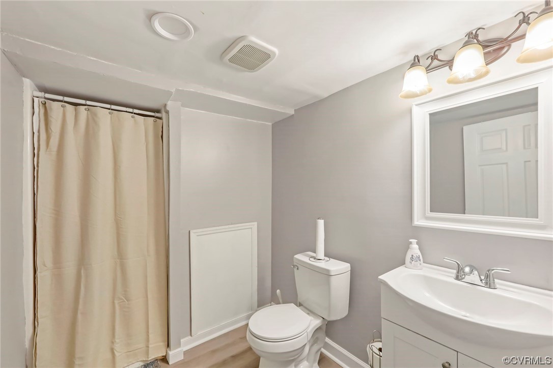 3248 West Hundred Road Chester, VA 23831 - Photo 25 of 27 a bathroom with a toilet a sink and a mirror