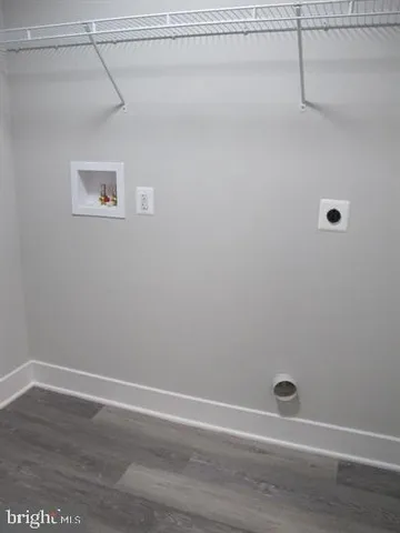 a large kitchen with cabinets and wooden floor