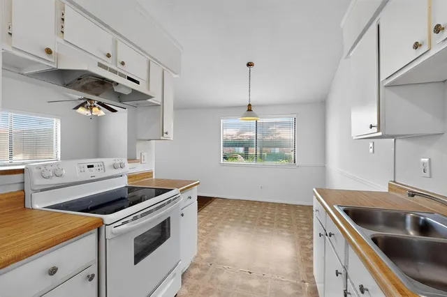 a kitchen that has a sink and a stove