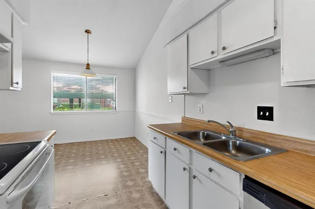 a kitchen with kitchen island a sink stove and cabinets