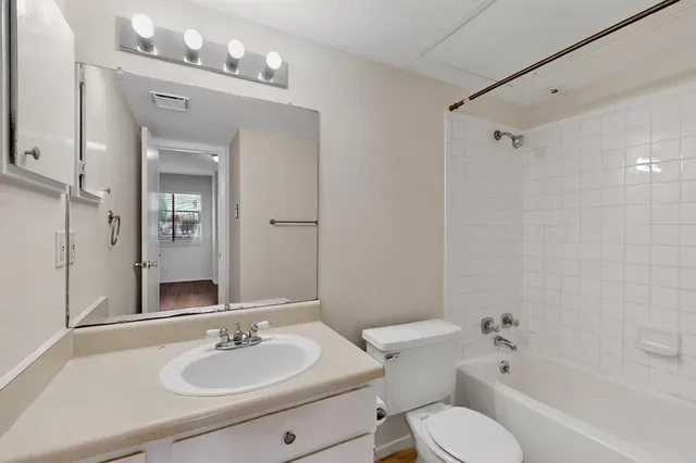 a bathroom with a sink toilet tub and shower