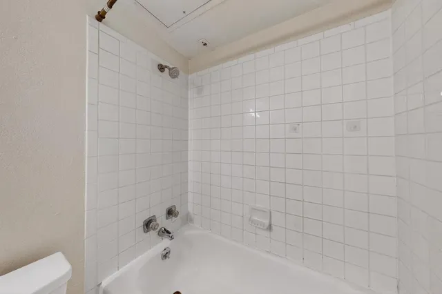a bathroom with a bathtub and shower
