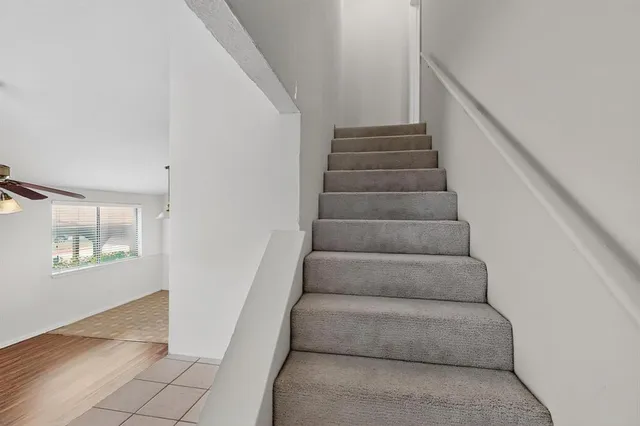 a view of staircase with white walls and windows