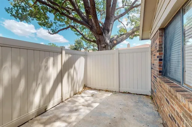 a view of a backyard with a large tree