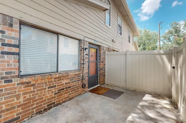 a view of a small house with backyard