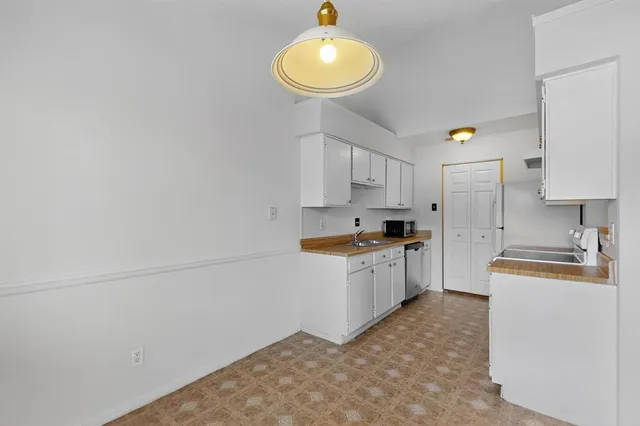 a kitchen with a sink cabinets and a refrigerator