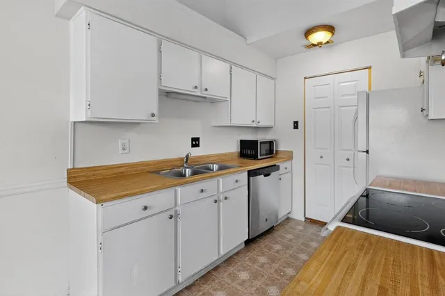 a kitchen with cabinets appliances and a sink
