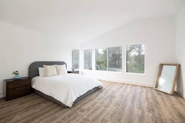 a bedroom with a large bed and a large window