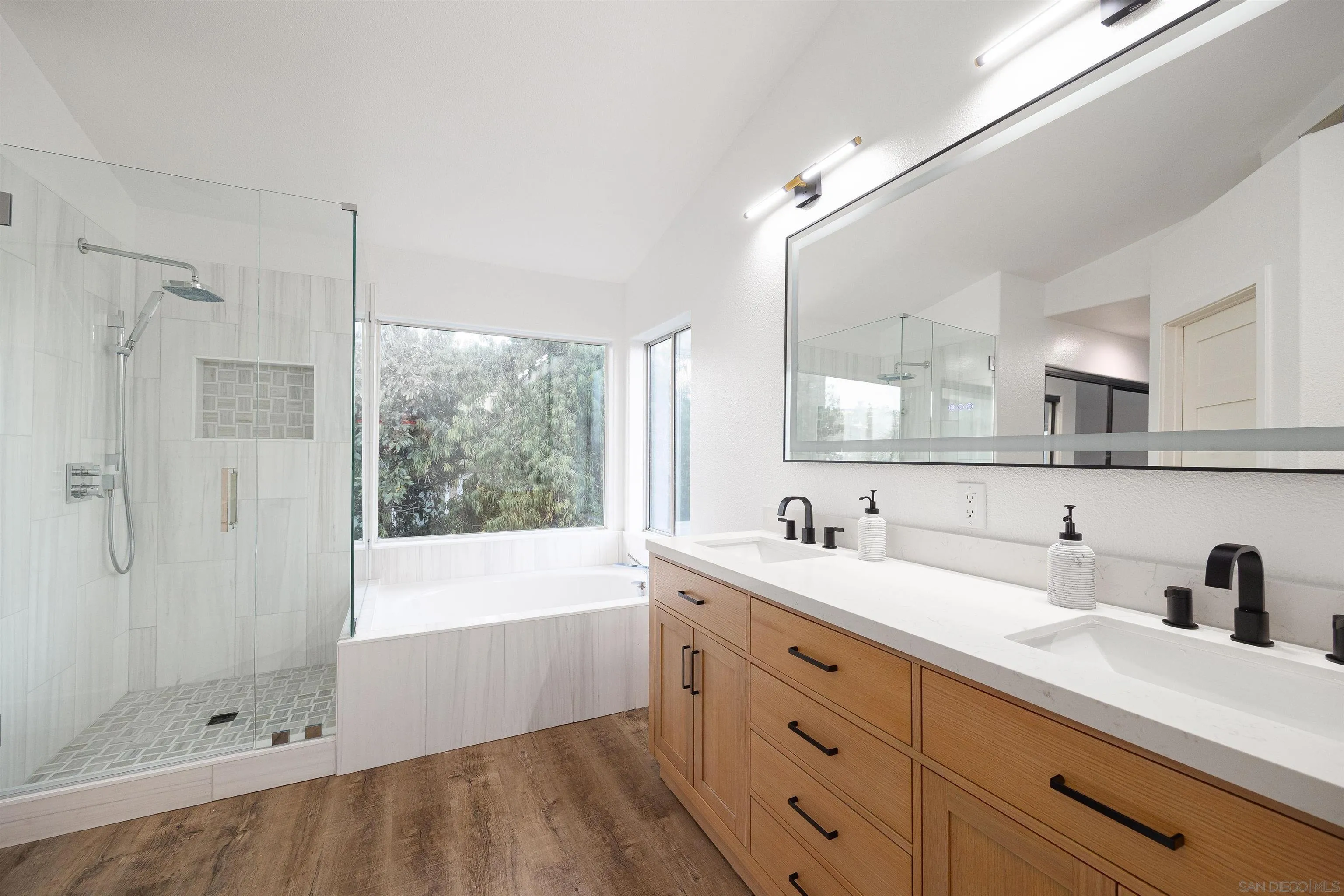 2318 Via Villegas Carlsbad, CA 92009 - Photo 13 of 37 a bathroom with a tub sink and mirror