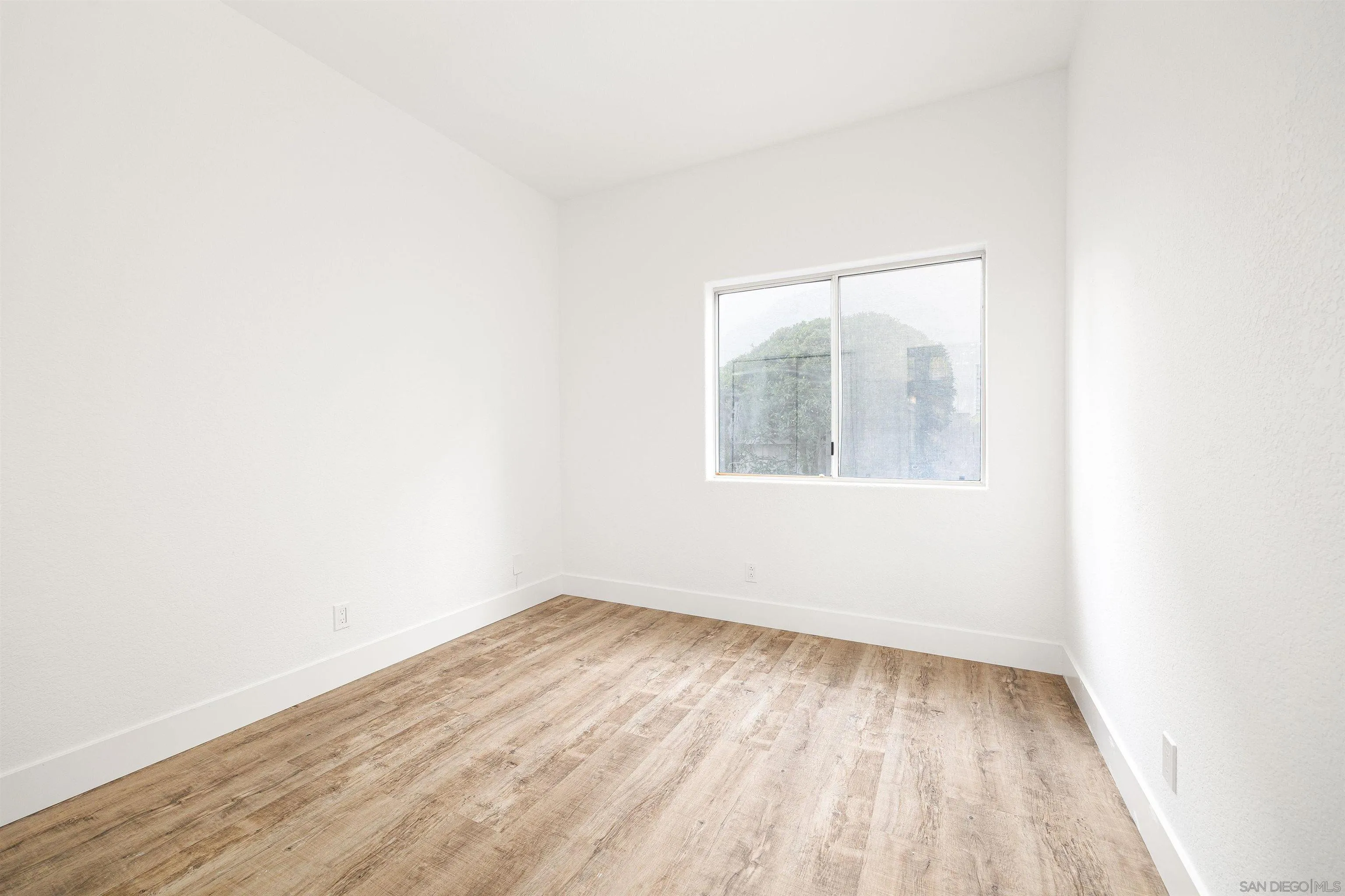 2318 Via Villegas Carlsbad, CA 92009 - Photo 15 of 37 an empty room with wooden floor and windows