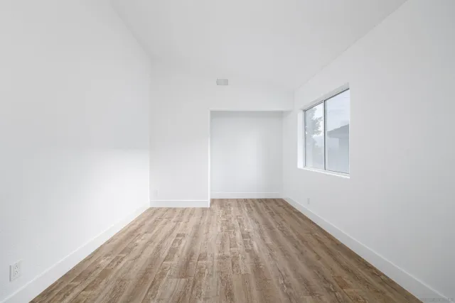 a view of room with window and hardwood floor