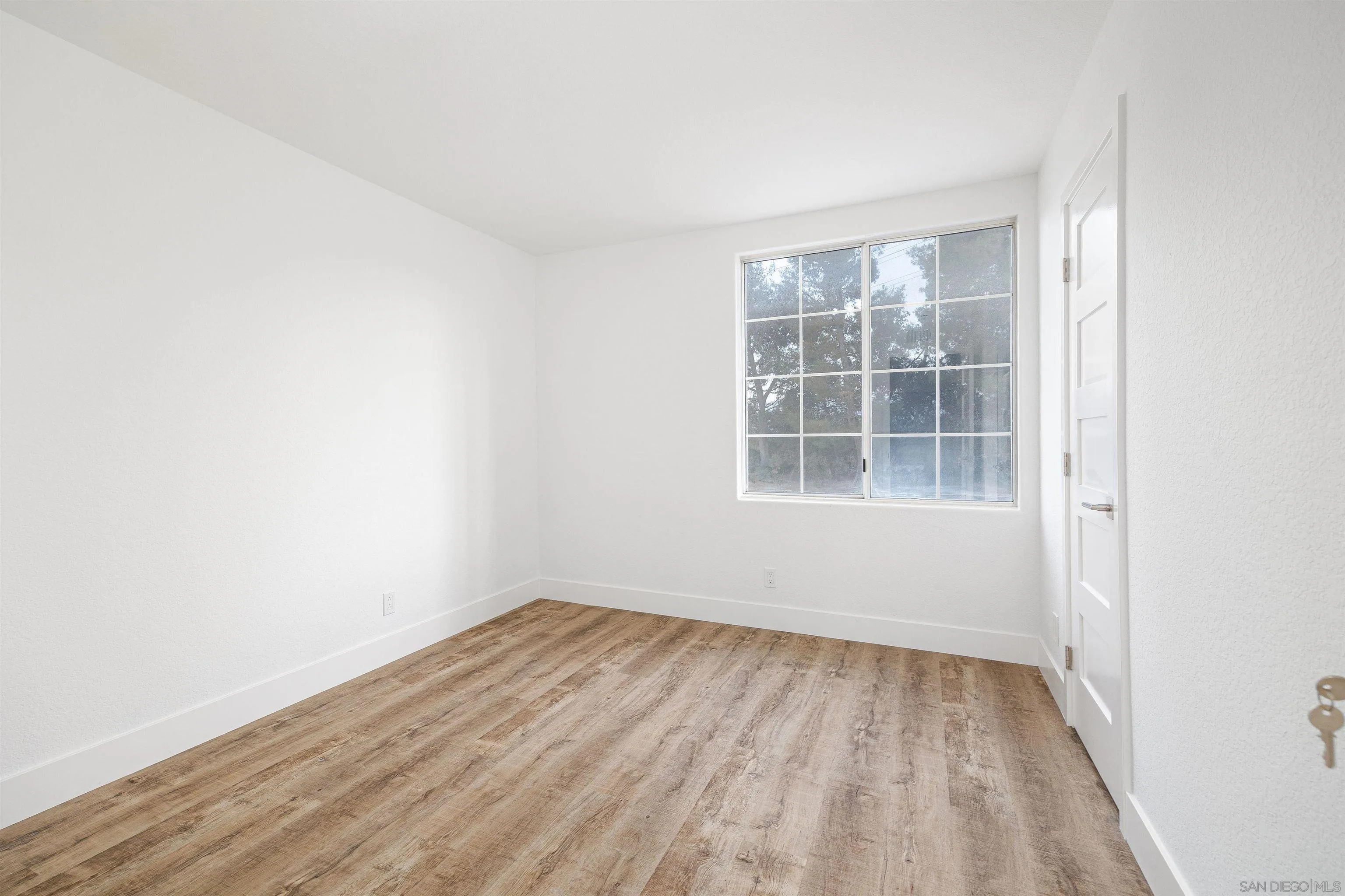 2318 Via Villegas Carlsbad, CA 92009 - Photo 20 of 37 a view of empty room with wooden floor and fan
