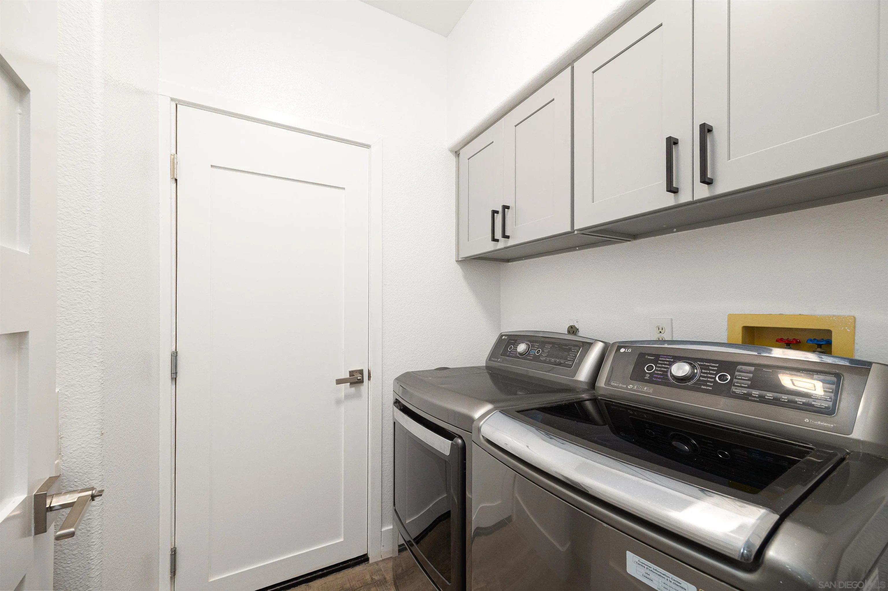 2318 Via Villegas Carlsbad, CA 92009 - Photo 23 of 37 a kitchen with a stove and a white cabinet