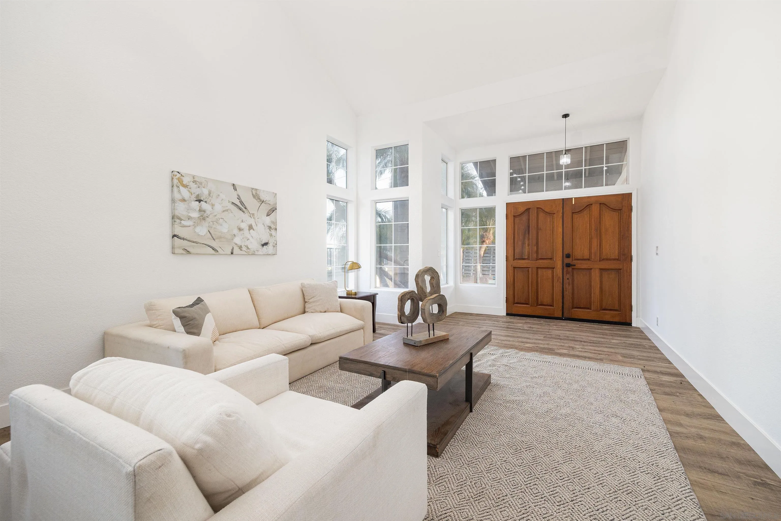 2318 Via Villegas Carlsbad, CA 92009 - Photo 4 of 37 a living room with furniture a rug and white walls