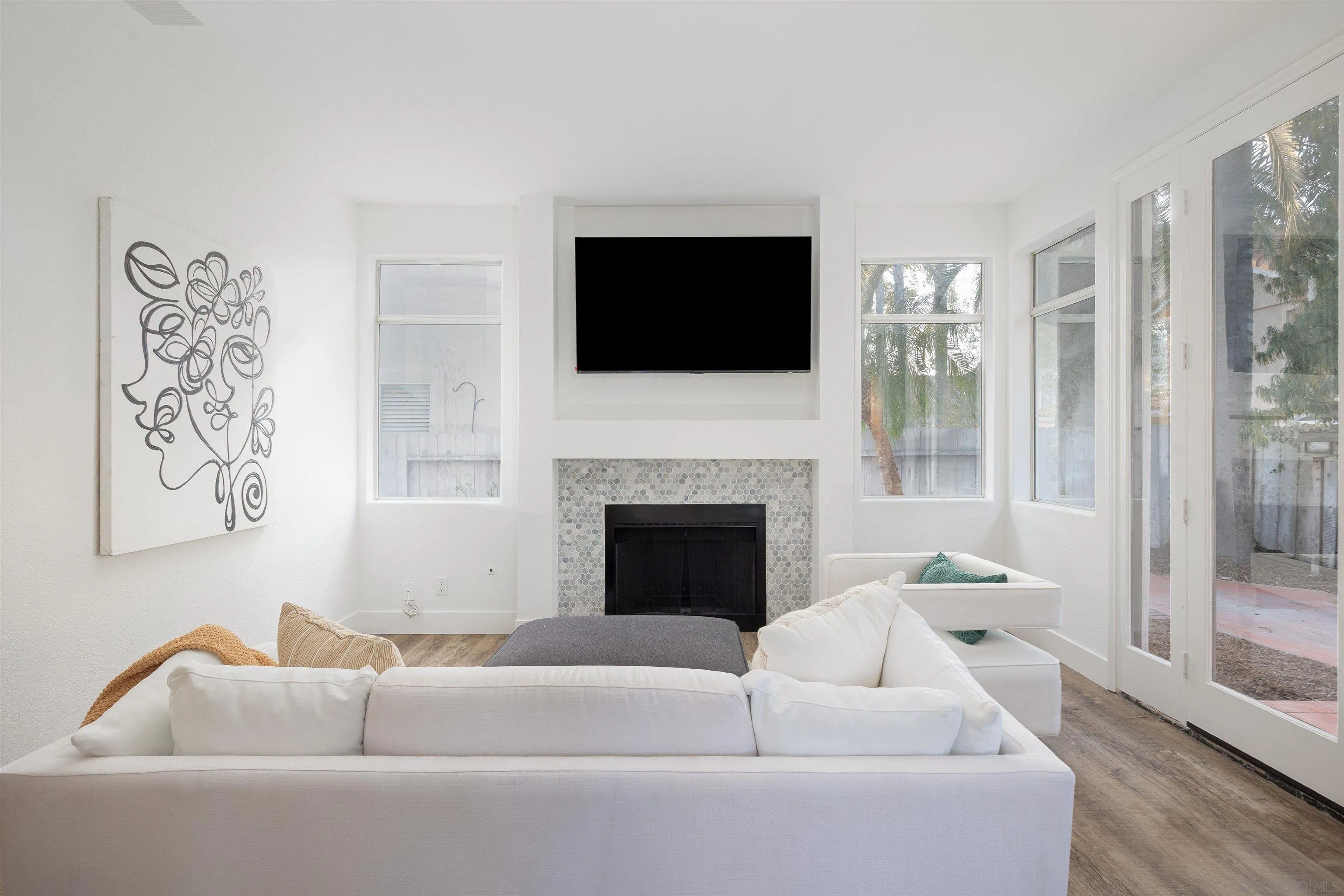 2318 Via Villegas Carlsbad, CA 92009 - Photo 10 of 37 a living room with furniture a flat screen tv and a fireplace