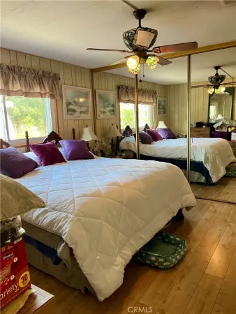 a bedroom with a bed mirror and window