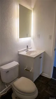 a white toilet sitting next to a bathroom sink