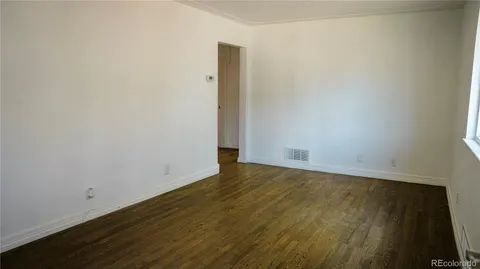 an empty room with wooden floor