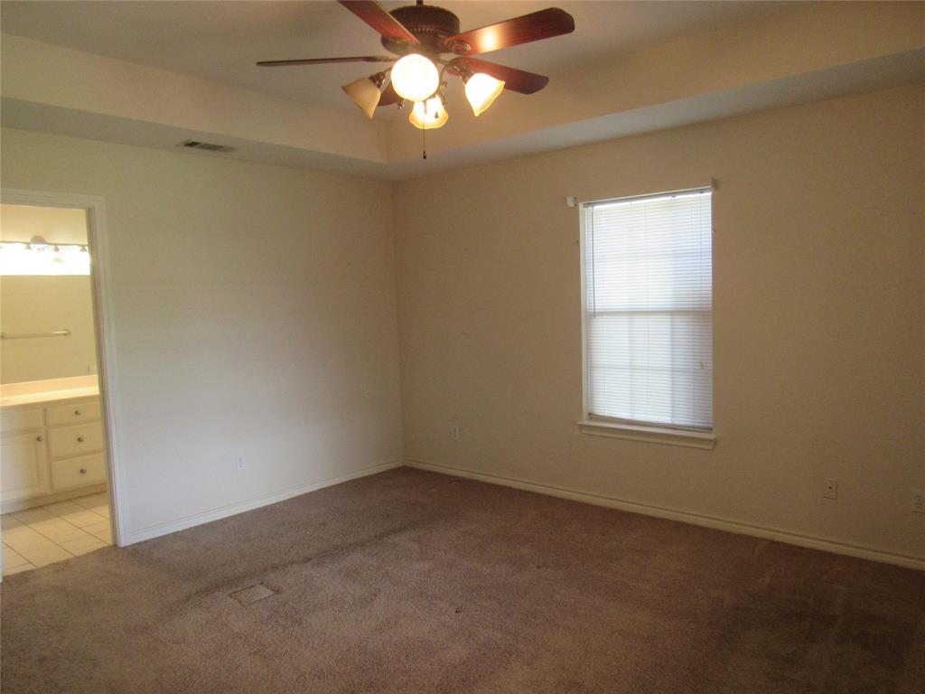 4019 East Fm 120 Denison, TX 75021 - Photo 19 of 39 en empty room with windows and chandelier fan