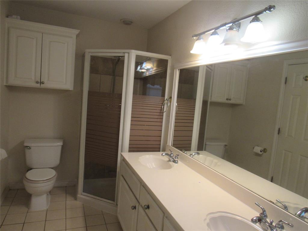 4019 East Fm 120 Denison, TX 75021 - Photo 23 of 39 a bathroom with a toilet sink and mirror